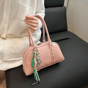 Detailed view of pink Boston bag with silver bear charm and YAZIANDI logo