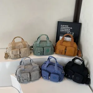 Versatile nylon tote bag available in six colors with dual handles and crossbody strap