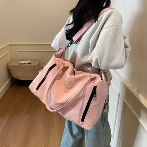 Close-up of pink fitness travel bag with adjustable shoulder strap and matte finish