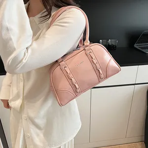 Close-up of pink leather Boston bag featuring woven texture and YAZIANDI brand lettering