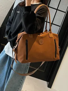 Brown large capacity travel duffel bag with front pockets and long shoulder strap