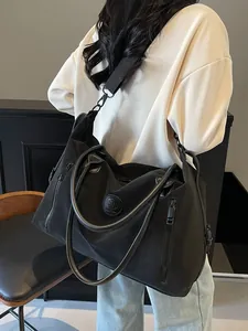 Black large capacity travel tote bag made of durable nylon with adjustable shoulder strap