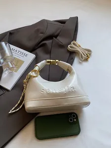Chic beige half-moon shoulder bag in smooth vegan leather with gold clasp and brand logo