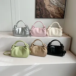 Close-up of pleated cloud bags with knot handles in six vibrant pastel colors
