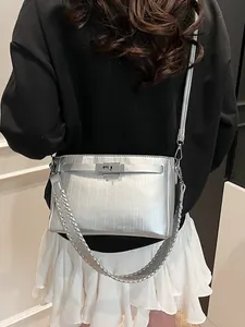 Silver metallic leather Kelly handbag with dual straps for shoulder and crossbody wear