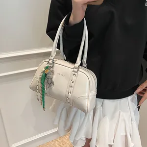 Cream white leather hobo bag with green braided rope and diamond bear charm decoration