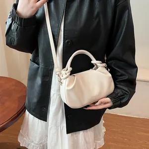 Detail of cream white pleated cloud handbag with adjustable strap and fashion logo