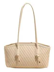 Chic cream tote bag with stylish wave pattern texture and gold-tipped knot shoulder straps