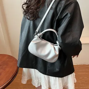 Detail of silver pleated cloud bag with FASHION & BAGS logo and crossbody strap