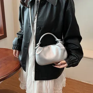 Detail view of silver pleated cloud bag with soft leather texture and metallic finish