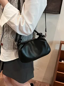 Minimalist black cloud handbag with knot handle and shoulder strap for women