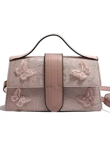 Pink lace handbag with floral texture and 3D butterfly appliqués on white background