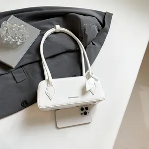 Detailed top view of white bowling bag with fashion lettering and protective metal feet