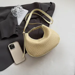 Detailed close-up of beige woven texture hobo bag with gold zipper and adjustable strap