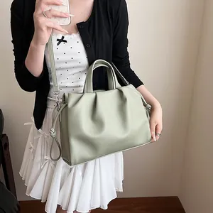 Sage green ruched cloud handbag featuring a soft leather texture and knotted drawstring details