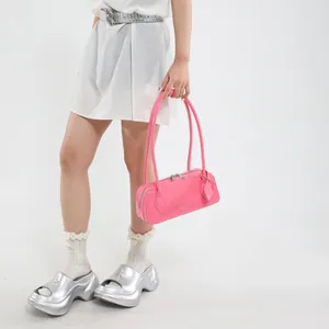 Pink patent leather bowling bag with silver zipper detail and matching charm pendant