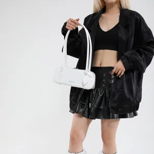 Detail of white glossy leather bag with FASHION & BAGS print and slim shoulder straps