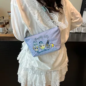 Close-up of cat embroidery and Naughty Kitty text on a light purple nylon crossbody bag