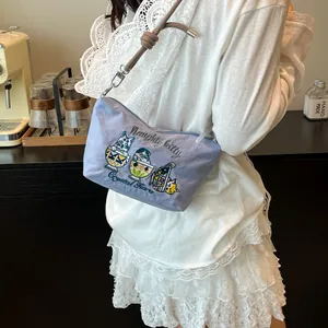 Detail of light purple fabric shoulder bag featuring delicate cat embroidery and brown rope strap