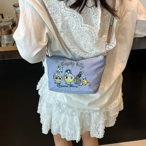Detailed embroidery of cute cartoon cats on a light blue nylon crossbody dumpling bag