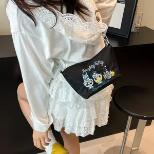 Detail of the black crossbody bag featuring cute cartoon cats embroidery on nylon fabric