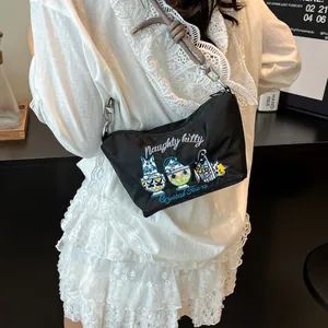 Close-up of black nylon shoulder bag featuring cute cat embroidery and naughty kitty text