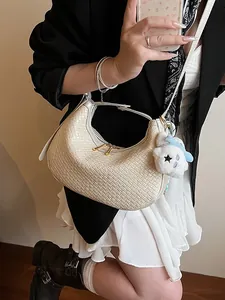 White woven hobo bag for women with crescent shape and plush charm accessory