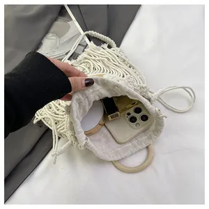 Detailed interior of bohemian woven bag with wooden handles and ample storage space