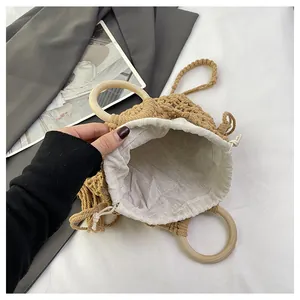 Detail view of the hand-woven bucket bag with wooden ring handles and cotton liner