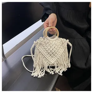 Close-up of Bohemian woven handbag featuring intricate V-shaped patterns and long tassels