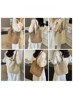 Detail of woven mesh tote bag in beige and khaki with slim brown leather straps