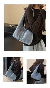 Detailed view of the large capacity denim tote bag showing vintage washed blue fabric and stitching