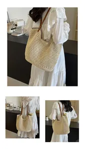 Detail of hollow knit mesh texture and brown leather strap on cream crochet tote bag