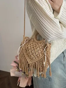 Bohemian handwoven hollow handbag with tassels and round wooden handles in camel color