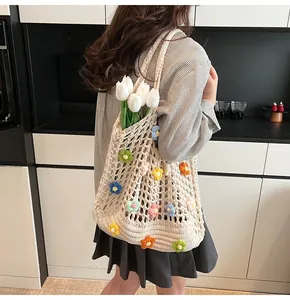 Dettaglio della borsa tote all'uncinetto con fiori 3D colorati e design traforato