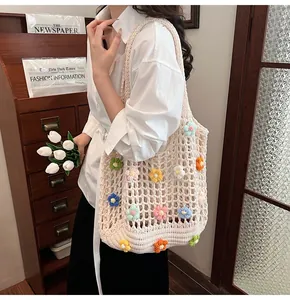 Dettaglio della borsa tote all'uncinetto con fiori 3D colorati e trama tessuta