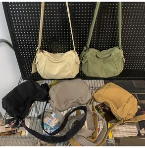 Detailed display of canvas crossbody bags in multiple colors with adjustable wide straps