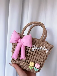 Handwoven basket bag with pink bow, tulip charms and Goodday embroidery for beach vacation
