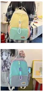 Detail of colorful nylon backpack with contrast panels and adjustable straps for kids
