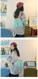 Detail of color-block canvas backpack with mint green and purple stitching and brand label
