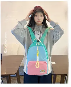 Detail of color block backpack with blue and pink panels and adjustable straps