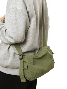 Army green canvas messenger bag with adjustable strap and side pocket on white background