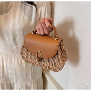 Close-up of retro woven handbag with brown leather flap and golden metal clasp