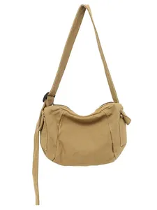 Minimalist khaki canvas messenger bag with adjustable shoulder strap and side pockets
