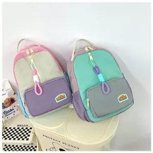Detail of colorful patchwork nylon backpacks with TOCHASO outdoor logo and zip charms