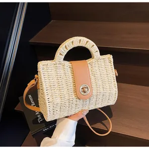 Detailaufnahme der handgefertigten Strohtasche mit feiner Textur und Lederklappe