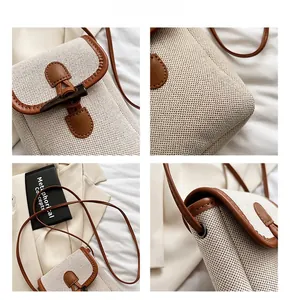 Detail showing vintage horn buckle closure and woven canvas texture of the crossbody bag