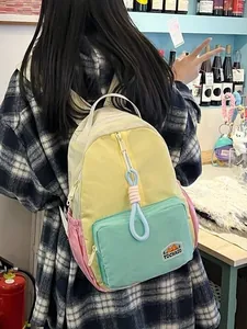 Colorful patchwork nylon backpack for students featuring yellow pink and mint green panels