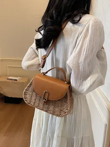 Vintage woven straw and brown leather crossbody bag styled with white striped summer dress