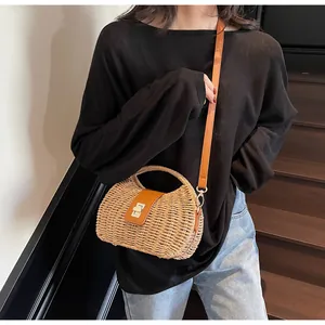 Detailansicht der Boho-Strohtasche mit braunem Lederverschluss und Drehschloss